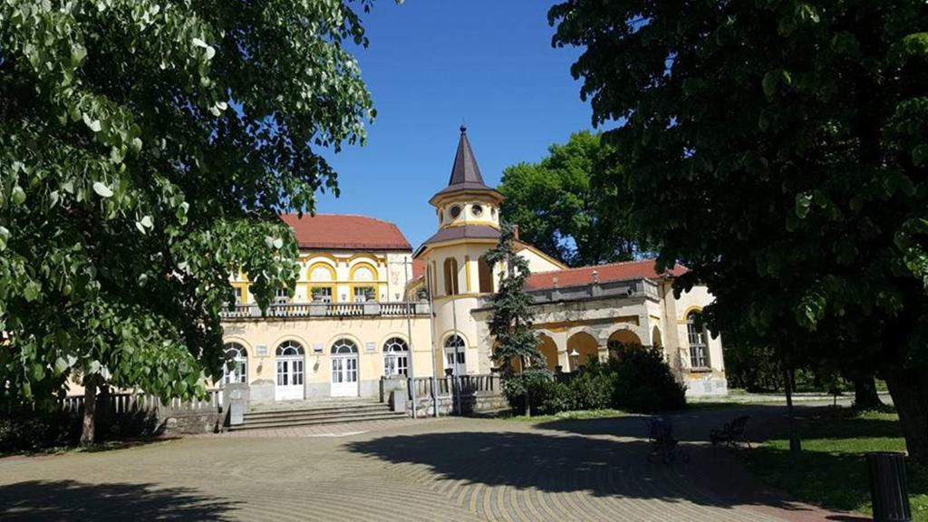 a large building with a tower on top of it at Hotel Royal Spa in Banja Koviljača