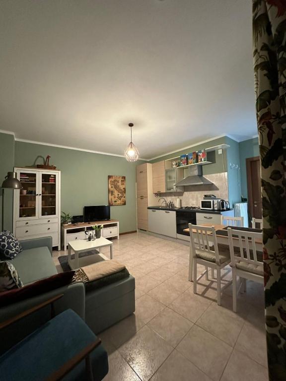 a living room and kitchen with a couch and a table at Appartamento a Luino Cavallotti25 in Luino