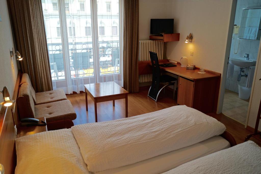 Postel nebo postele na pokoji v ubytování Hotel Victoria
