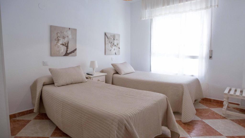 Posteľ alebo postele v izbe v ubytovaní Hostal Jomarijo