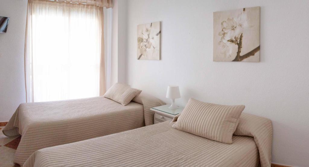 Posteľ alebo postele v izbe v ubytovaní Hostal Jomarijo