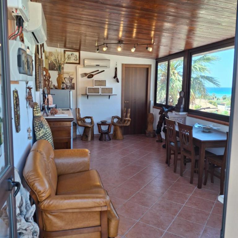 a living room with a couch and a table at La Foggia seaside paradise in Siculiana