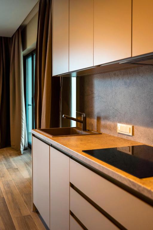 a kitchen with a sink and a counter top at VSG Resort - Relaxing Apartments, 200m from the Sea, with Pool, Sauna & Jacuzzi in Klimno