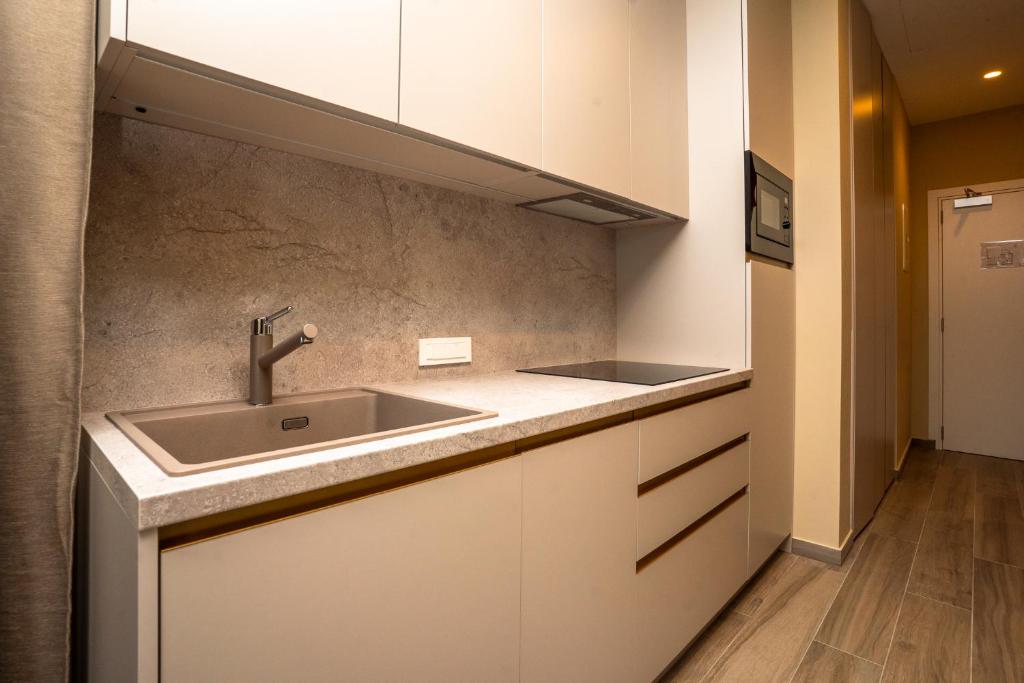a kitchen with a sink and a counter at VSG Resort - Relaxing Apartments, 200m from the Sea, with Pool, Sauna & Jacuzzi in Klimno