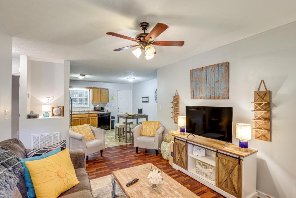 a living room with a couch and a flat screen tv at 3 Mi to Cherokee Reservoir Blue Haven Bungalow in Morristown