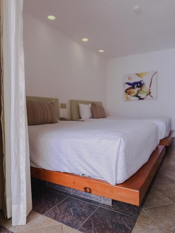 Postel nebo postele na pokoji v ubytování Hotel Los Patios