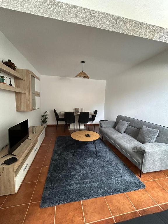 a living room with a couch and a table at Celina Residence in Ribeira Brava
