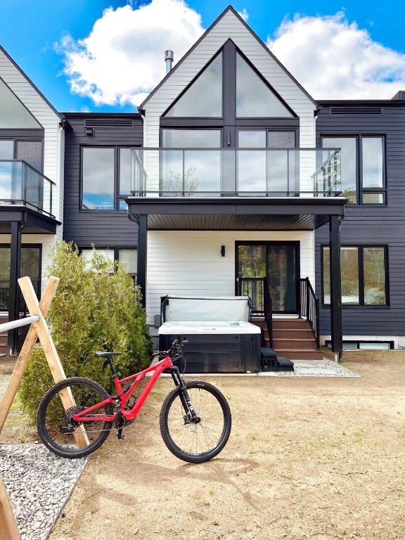 a red bike parked in front of a house at Villas Perspective Amandine Spa and Mountain in Beaupré