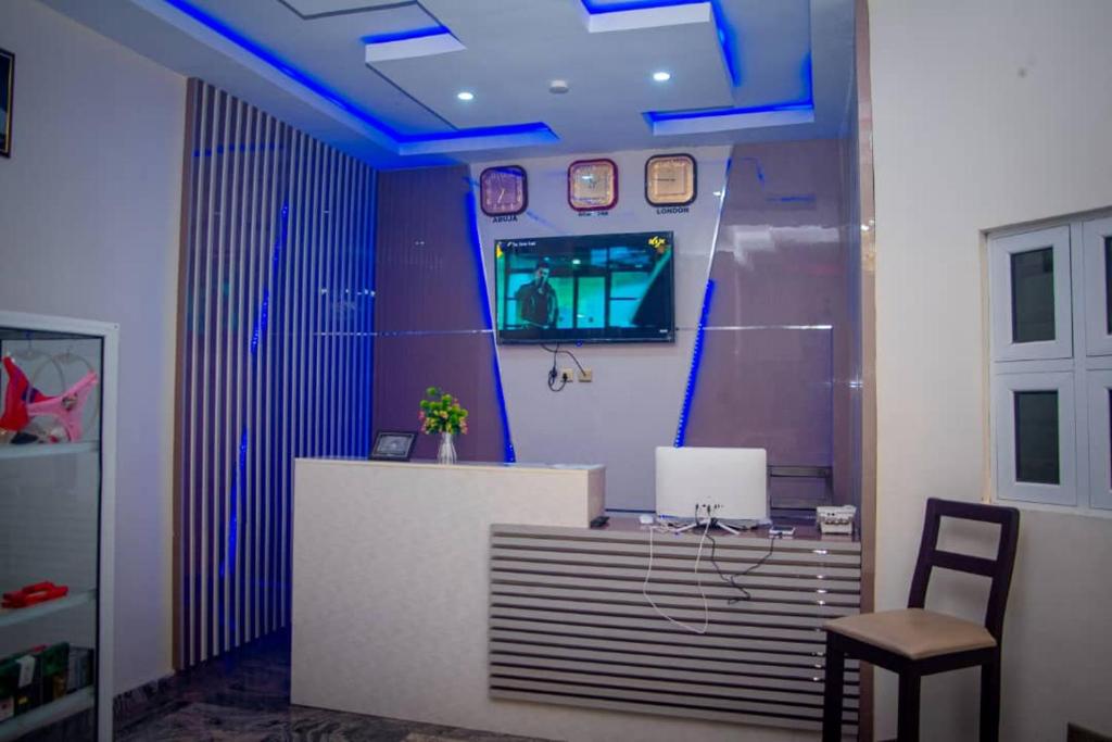 an office with a desk with a chair and blue lights at Diamond castle Hotel in Mama