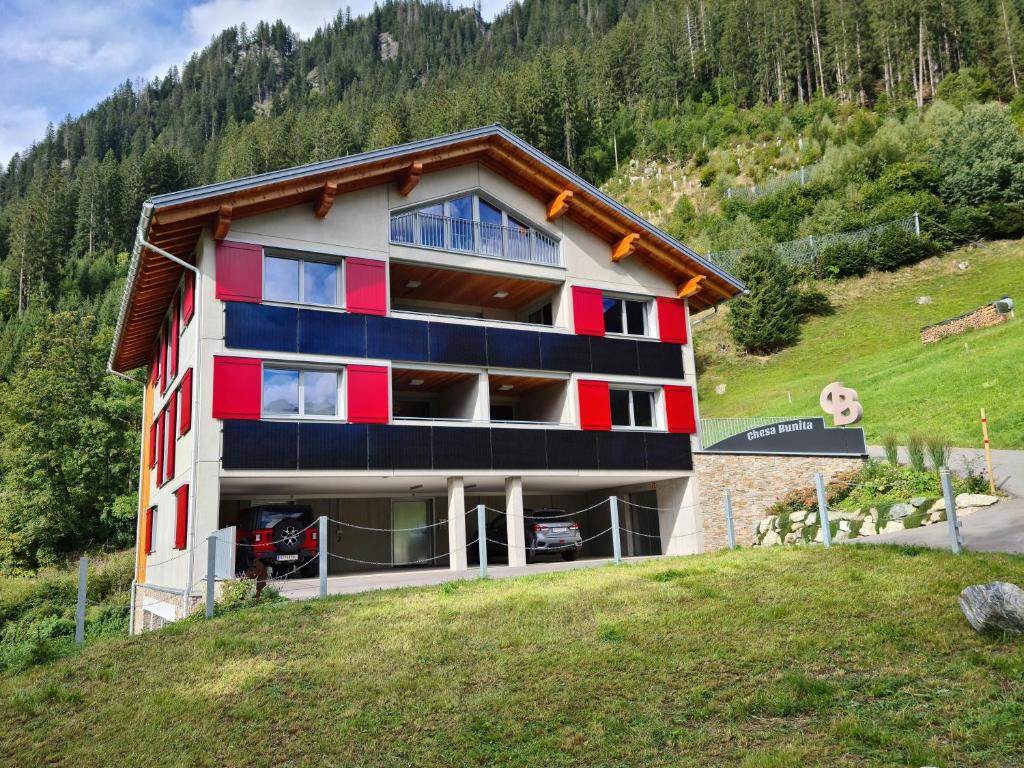a building with red and blue paint on it at Chesa Bunita Trais in Gaschurn