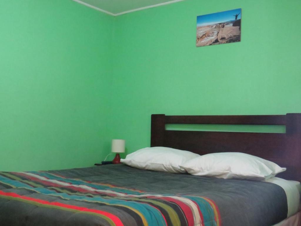 Postel nebo postele na pokoji v ubytování Hostal Mirador