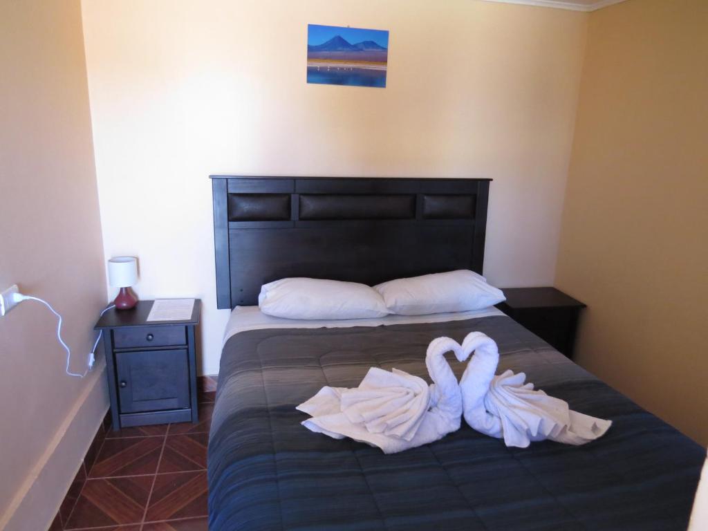 Postel nebo postele na pokoji v ubytování Hostal Mirador