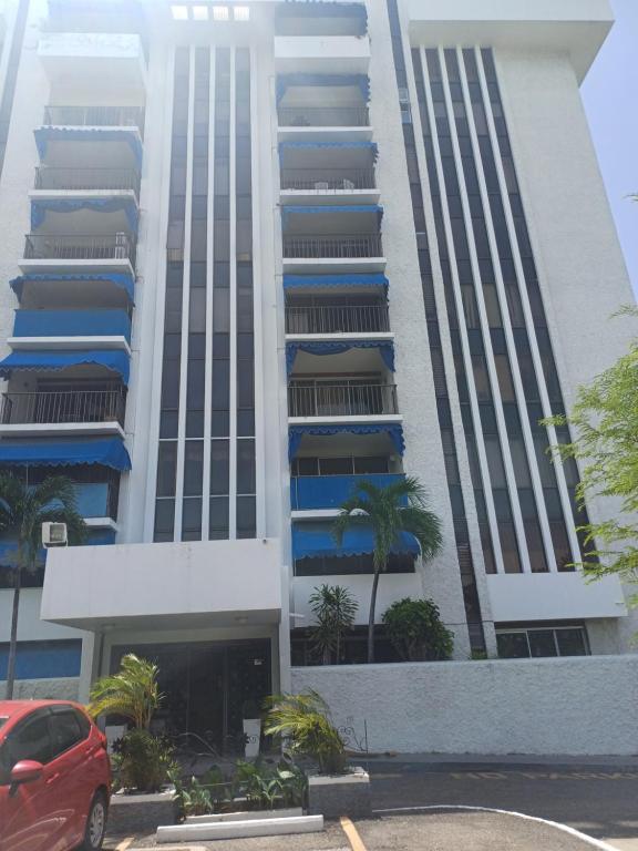 a tall building with a red car parked in front of it at royal at courtleigh towers in Kingston