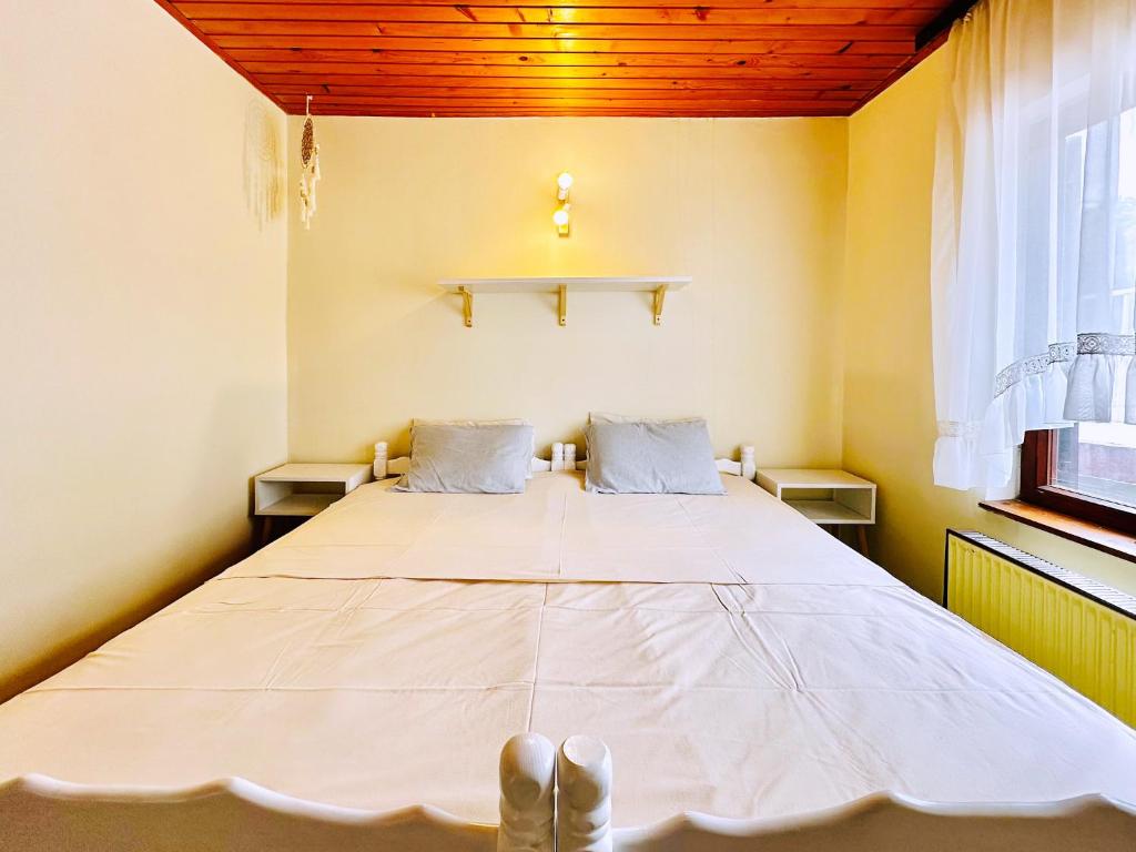 a large bed in a room with two windows at Princess of the Beach in Sutomore
