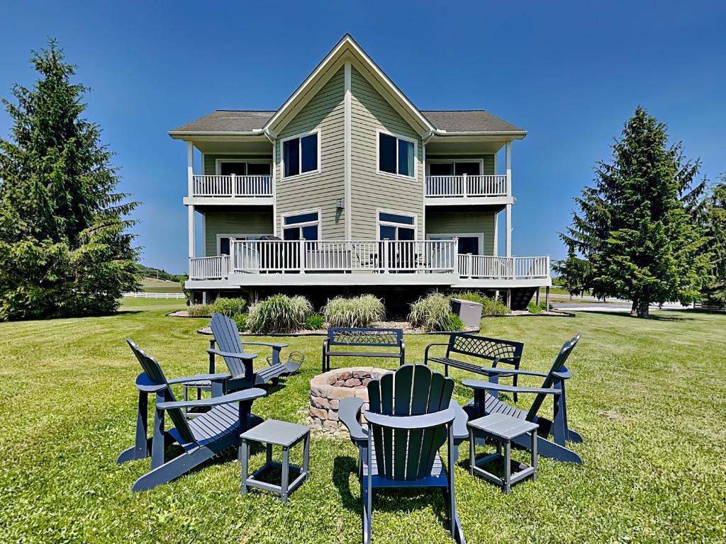 a house with chairs and a table in the yard at Dacha Verde in Swanton