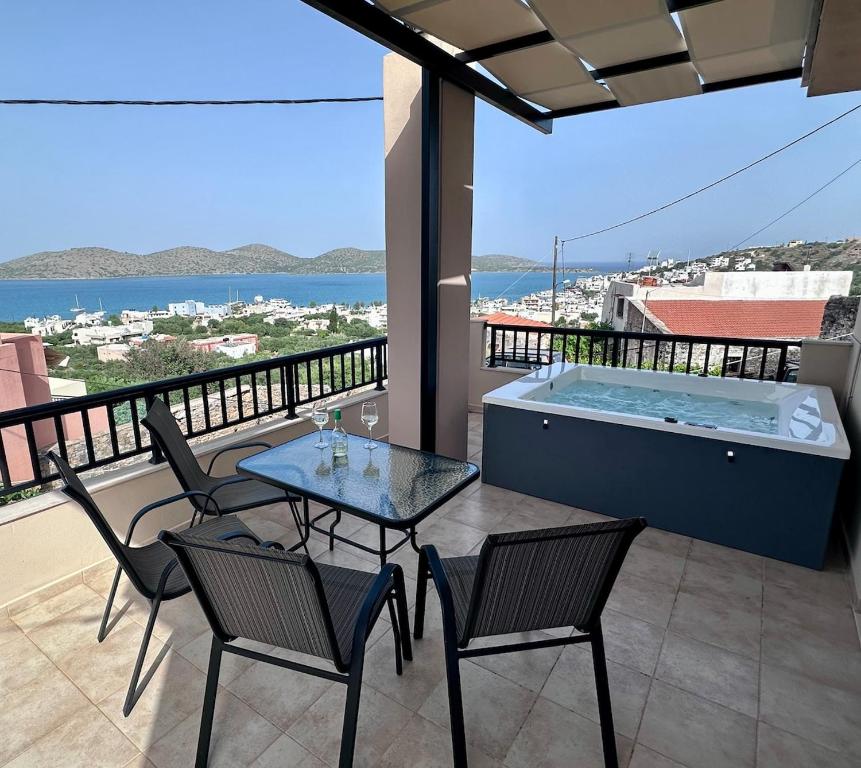 a patio with a table and chairs and a hot tub at Casa Betini Traditional Maisonette in Káto Eloúnda