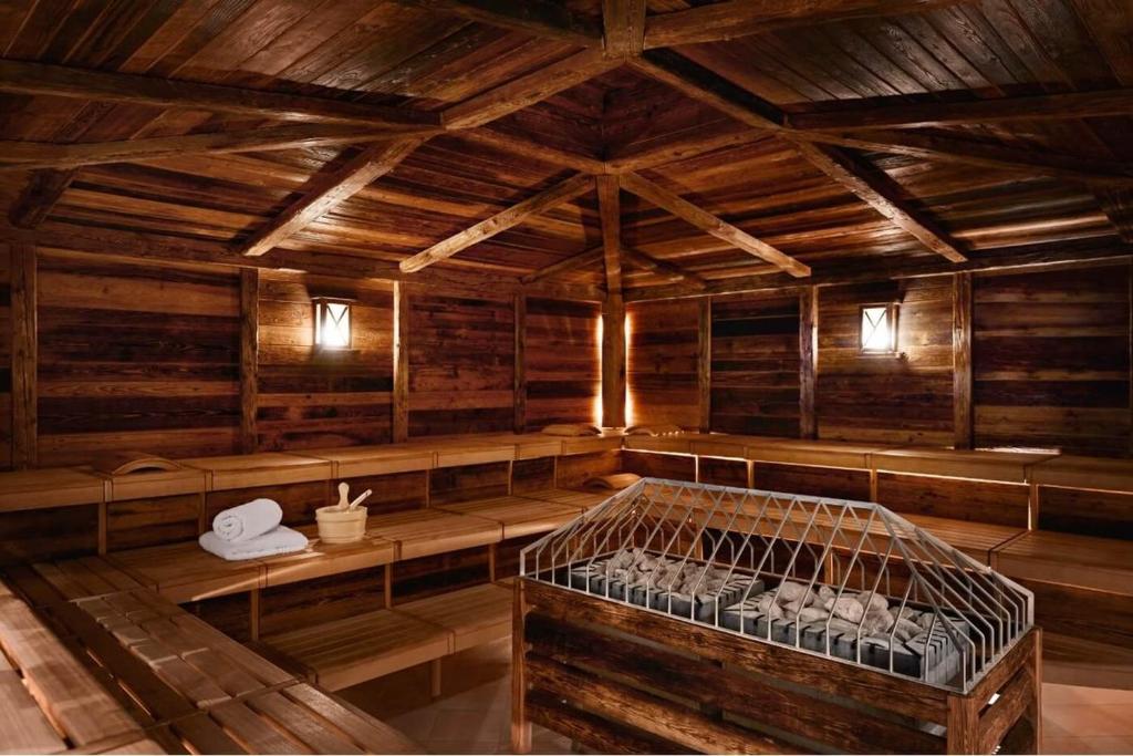a room with a bird cage in a wooden building at Grand Tirolia Kitzbühel - Member of Hommage Luxury Hotels Collection in Kitzbühel