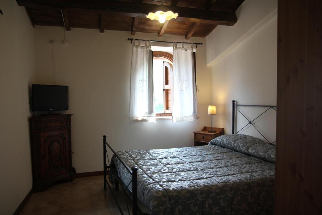 Postel nebo postele na pokoji v ubytování Agriturismo campagna in compagnia