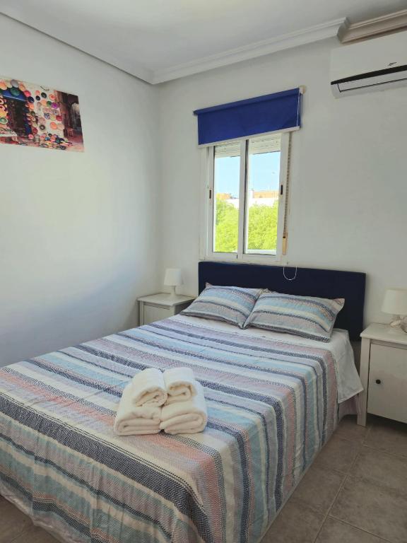 A bed or beds in a room at Enjoy Sevilla
