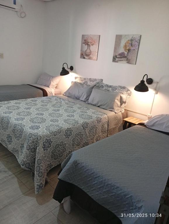 a bedroom with two beds and two lamps at Quinta Ogarupa in Corrientes