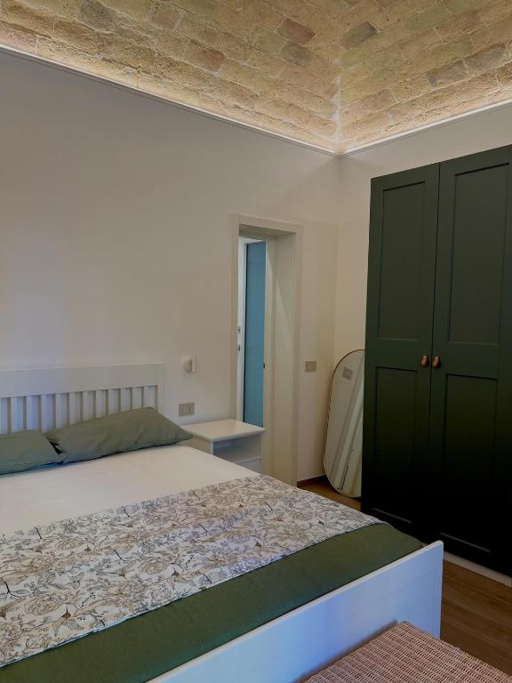 a bedroom with a large bed and green cabinets at Cledo Mare Luxury Stay - Armonia in Pescara