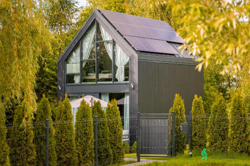 a house with solar panels on the roof at Dom w Starkowie, Basen i Sauna 