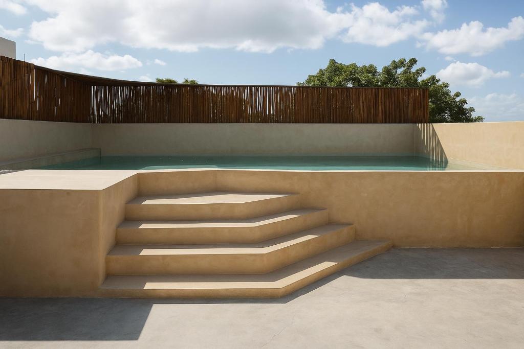 a concrete stairway with a wooden fence at Kassia Tulum in Tulum