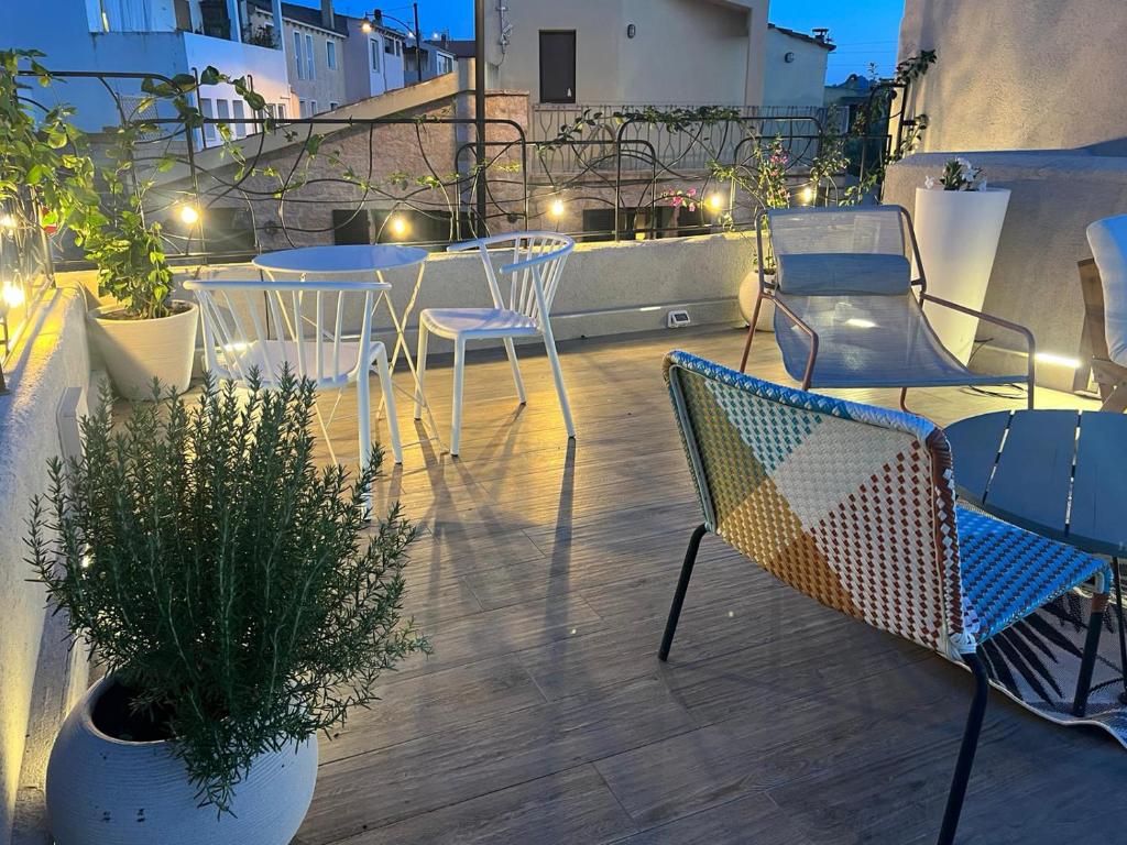 a patio with chairs and tables on a balcony at night at New ! Rayuela San Pantaleo in San Pantaleo