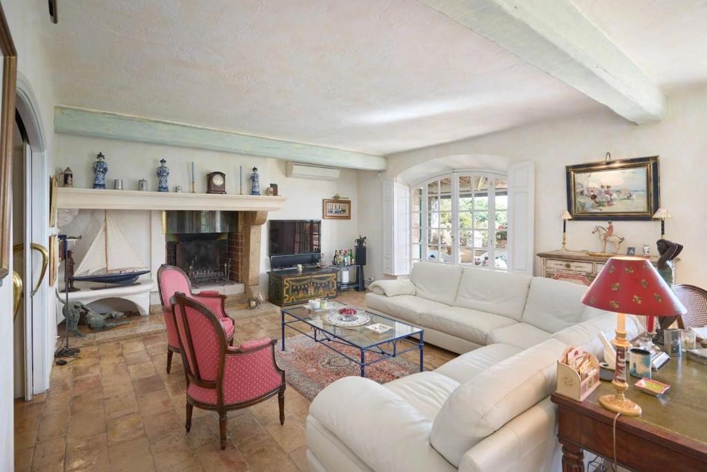 un salon avec un canapé blanc et une cheminée dans l'établissement La Bastide Vence, à Saint-Paul-de-Vence
