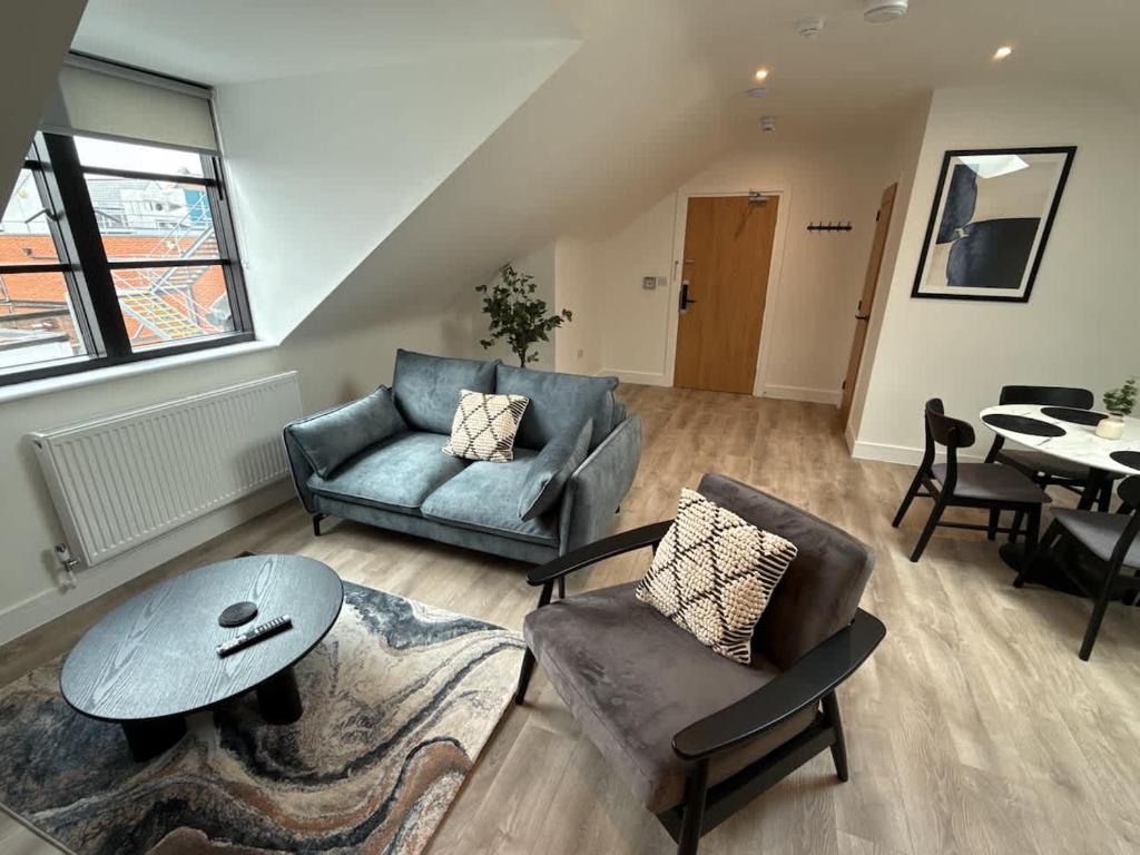 a living room with a couch and a table at Luxury 1 bed - 7 Queen Street Abingdon - Centrally located parking subject to availability in Abingdon