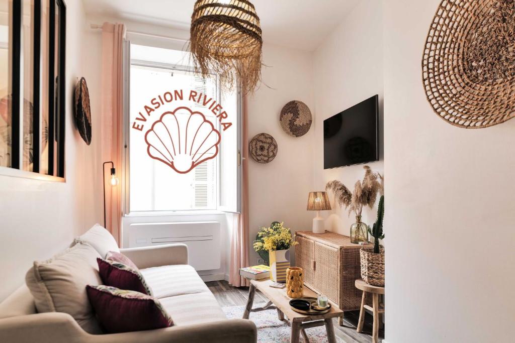 a living room with a white couch and a window at Saint Tropez - Old Village - Modern & Cosy Apartments in Saint-Tropez