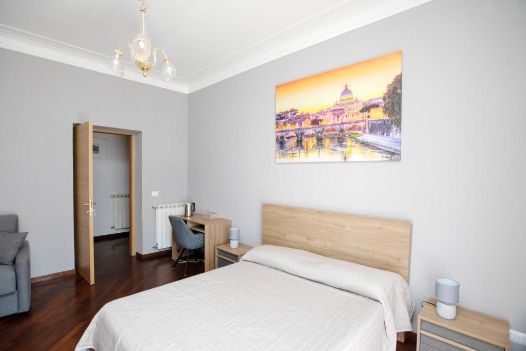 a bedroom with two beds and a painting on the wall at Relais Rosselli in Rome