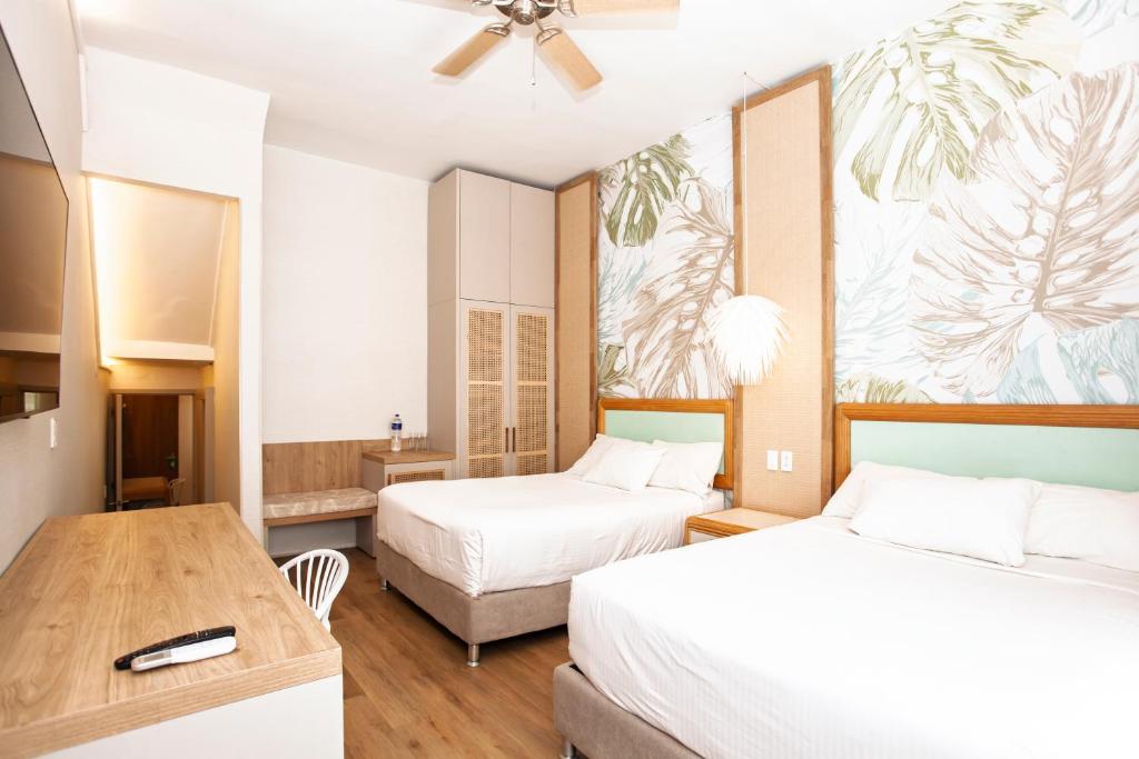 Cama o camas de una habitación en Hotel Cocoplum Beach
