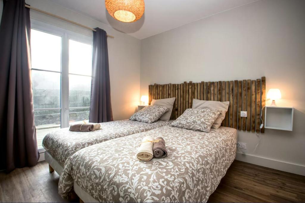 a bedroom with a bed with shoes on it at Ti Poulfoen in Plouescat