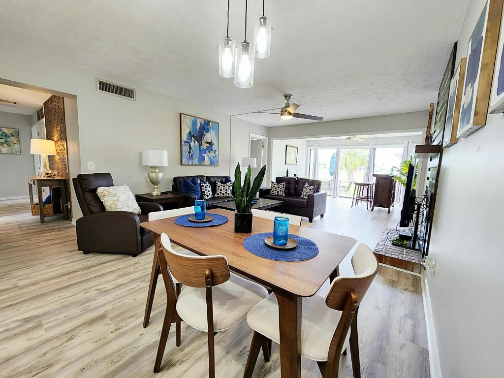 a dining room and living room with a table and chairs at Blue By The Bay in Panama City Beach