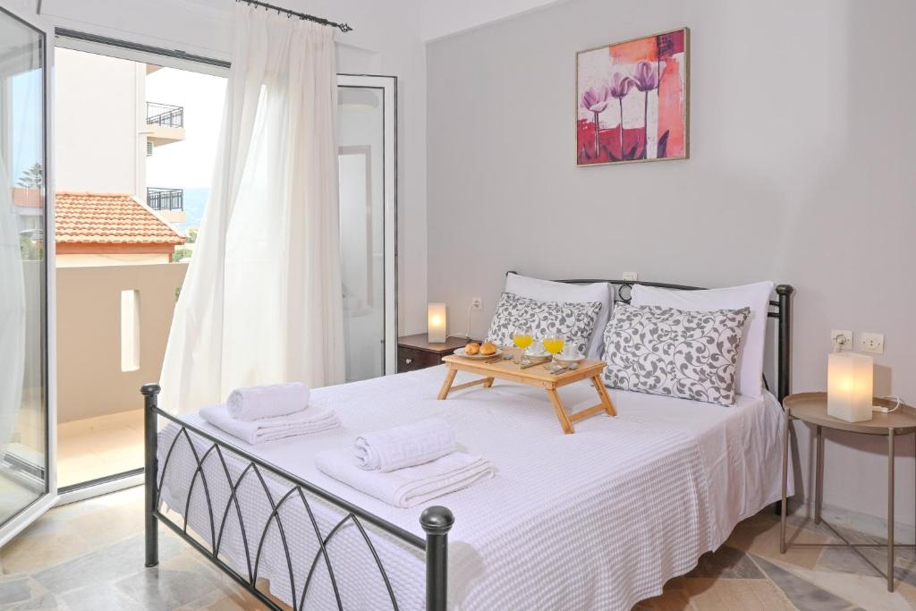 a bedroom with a bed with a table on it at Ammourin House in Ayía Marína