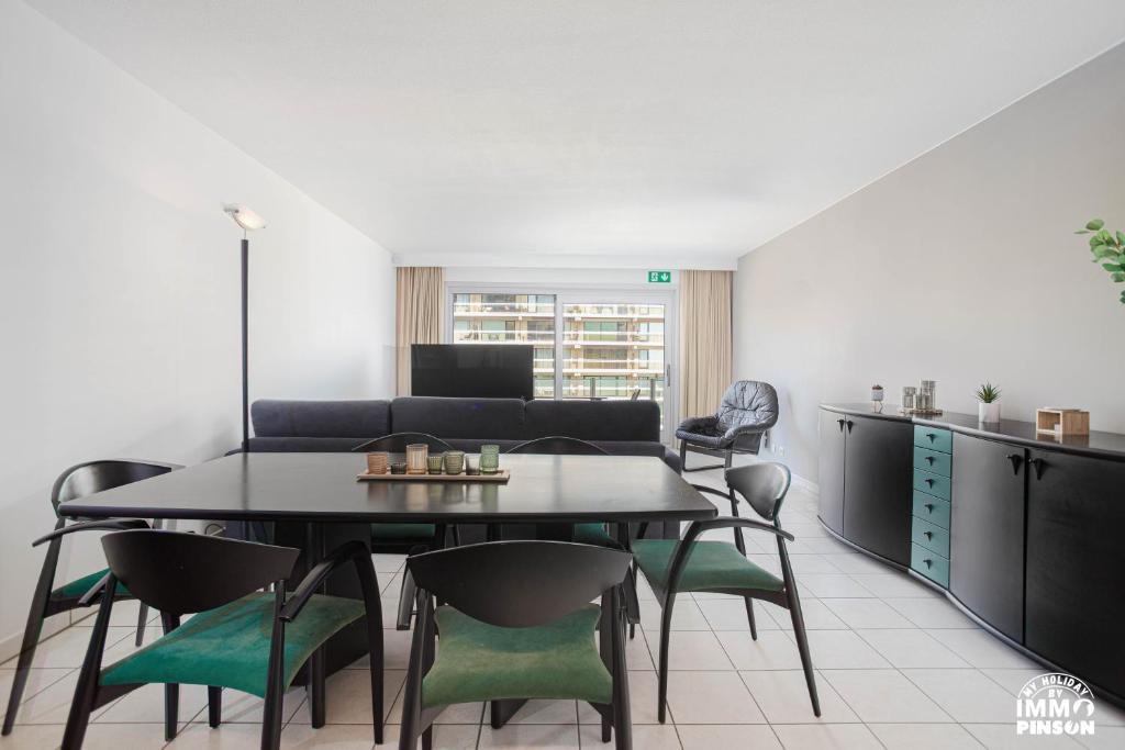 a living room with a black table and chairs at Europan A0502 Esplanade, stijlvol en vlakbij het strand in De Panne