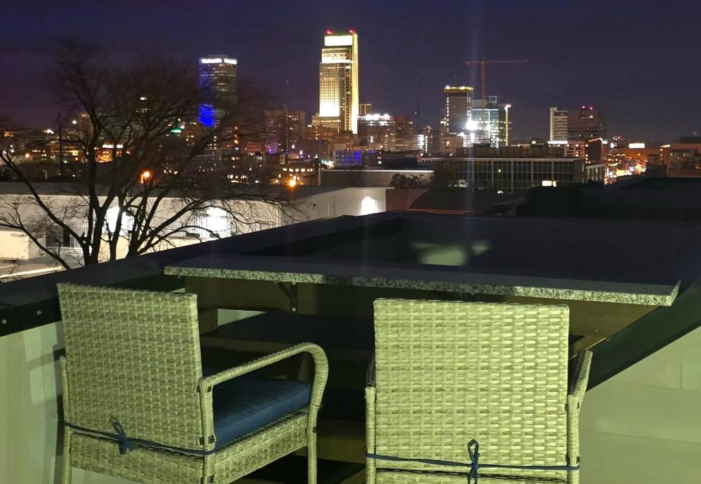two chairs on a balcony with a view of the city at Welcome to Luigi! in Omaha