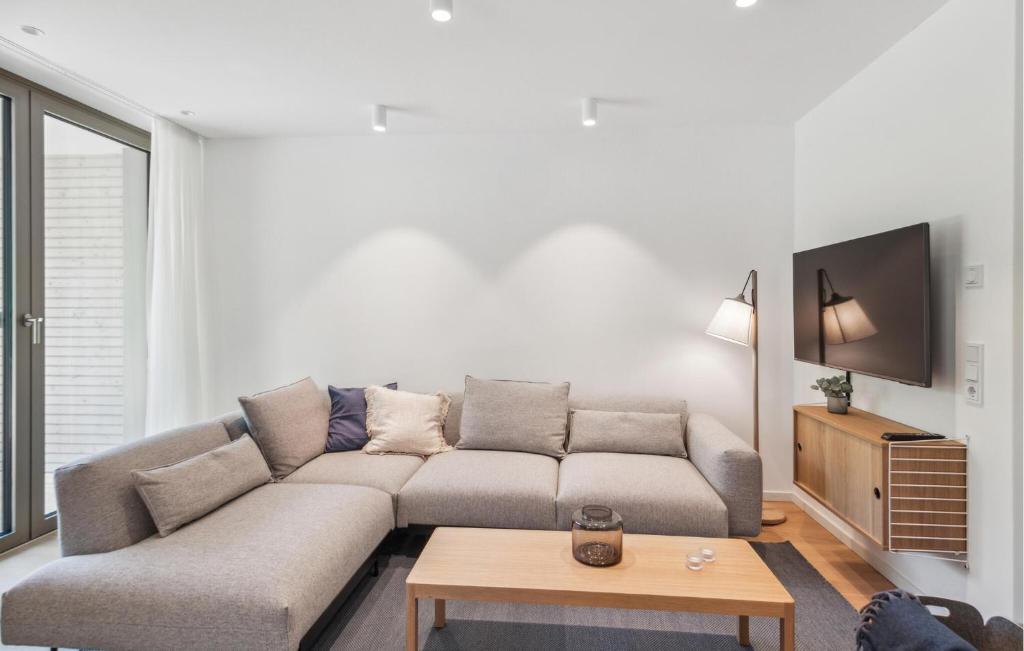 a living room with a couch and a table at Nice Apartment In Tossens With Kitchen in Stick