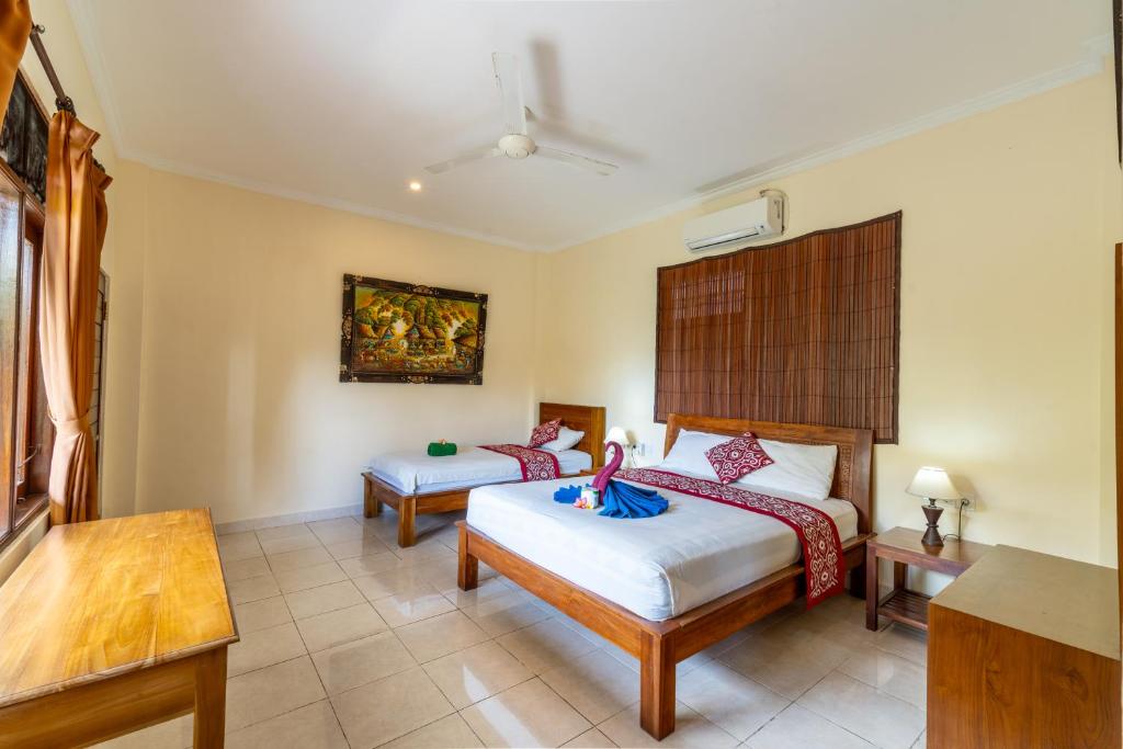 Postel nebo postele na pokoji v ubytování Rena House Ubud
