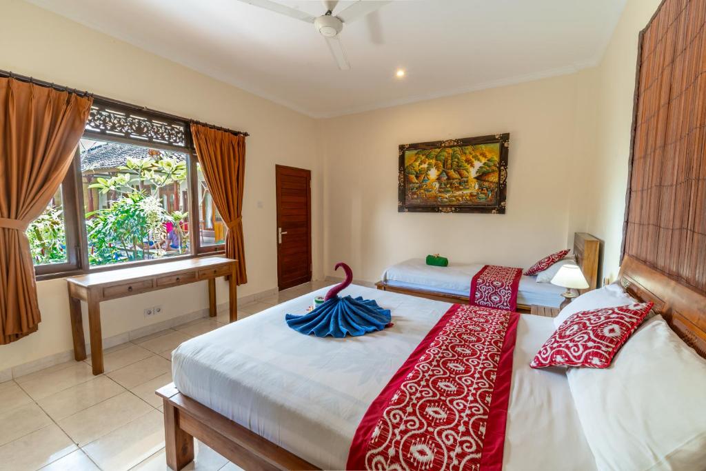 Postel nebo postele na pokoji v ubytování Rena House Ubud