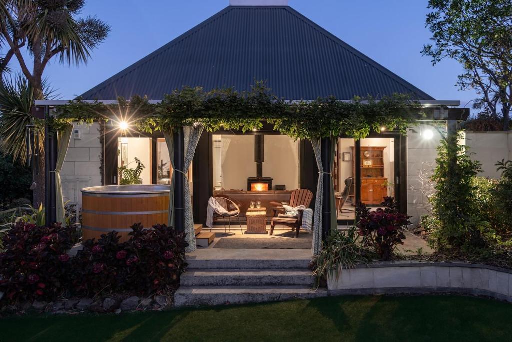 a house with a gazebo with a barrel at Sunrise Serenity with Hot Tub in Christchurch