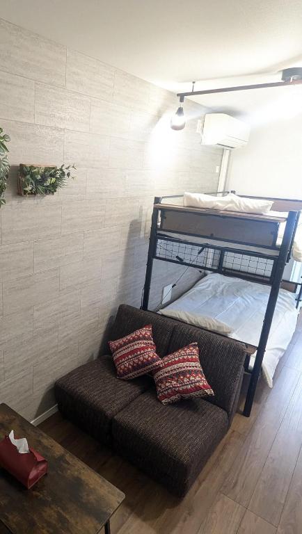 a couch in a room with a bunk bed at -Summer Escape- Just 15 min from Haneda Airport, Max 3 in Tokyo