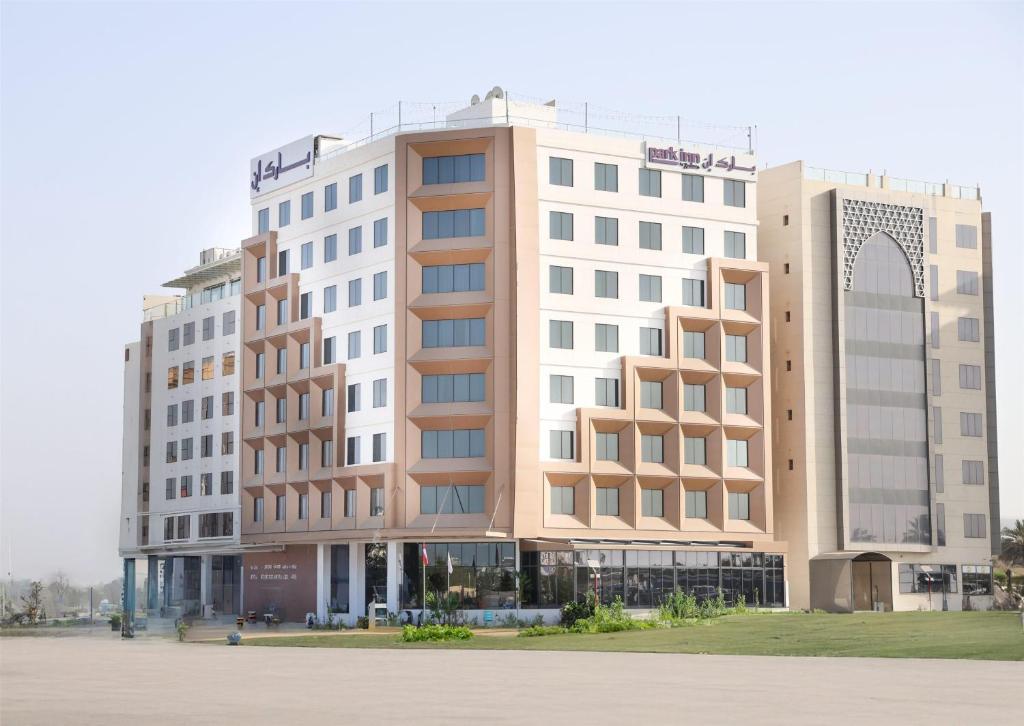 a building with two tall buildings next to each other at Park Inn by Radisson Muscat in Muscat