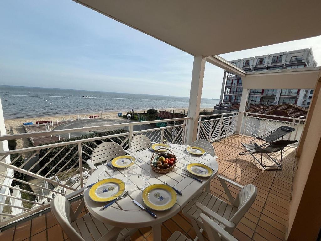 une table sur un balcon avec vue sur la plage dans l'établissement Appartement T3 en Bord de Mer à Arcachon avec Parking Sécurisé - FR-1-374-235, à Arcachon