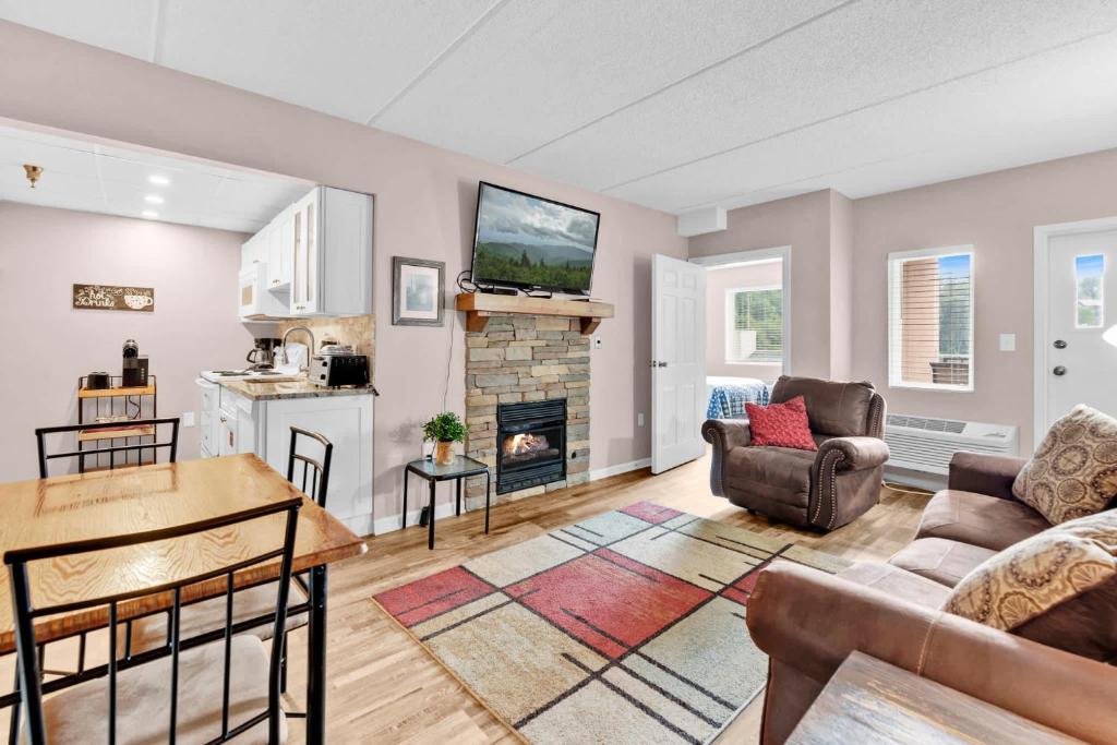 a living room with a couch and a fireplace at Trendy 2 BDR Condo with Pool & Hot Tub Near Downtown in Gatlinburg