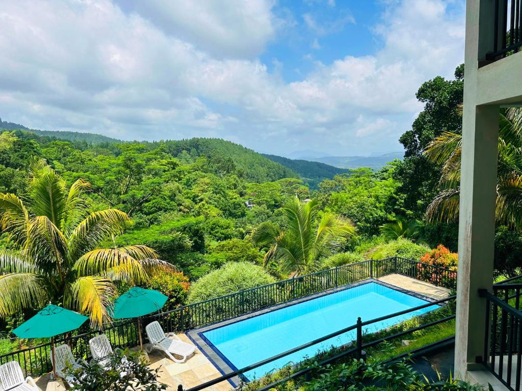 a swimming pool with a view of the mountains at Grand Hills kandy in Kandy