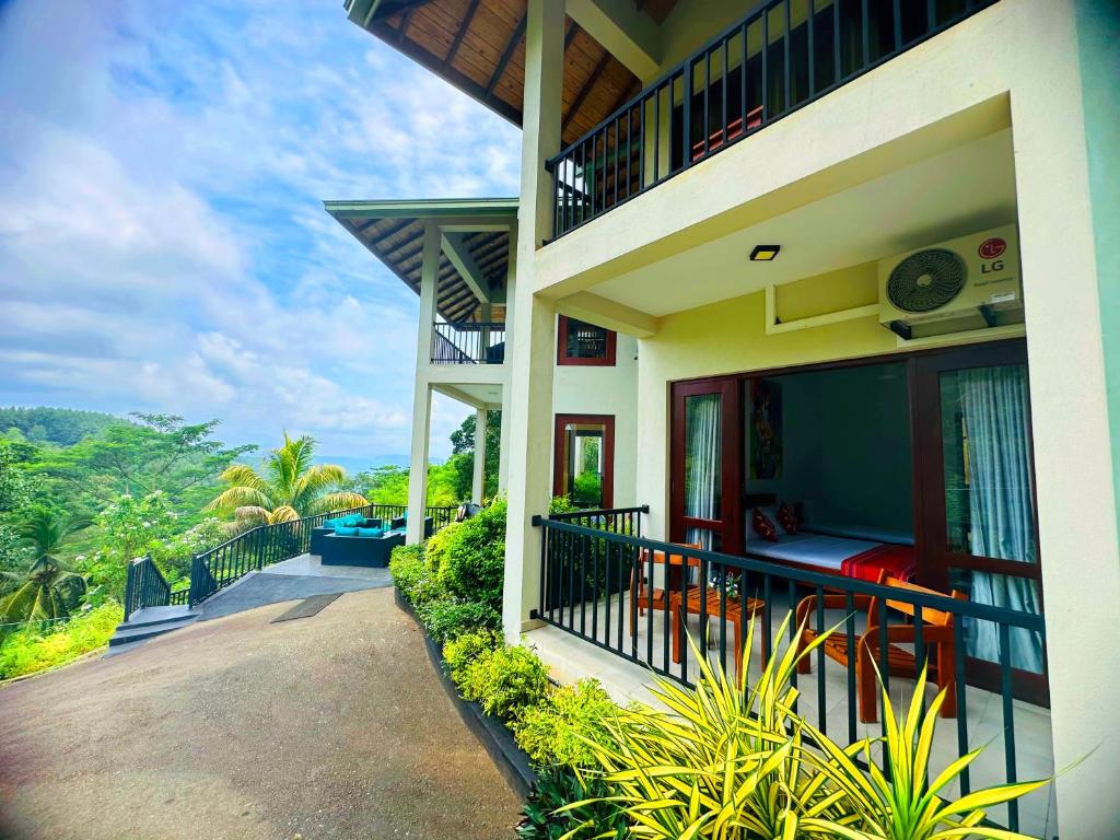 a house with a balcony with a view of the mountains at Grand Hills kandy in Kandy