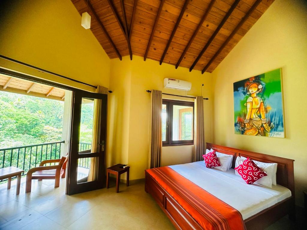 a bedroom with a bed and a balcony at Grand Hills kandy in Kandy