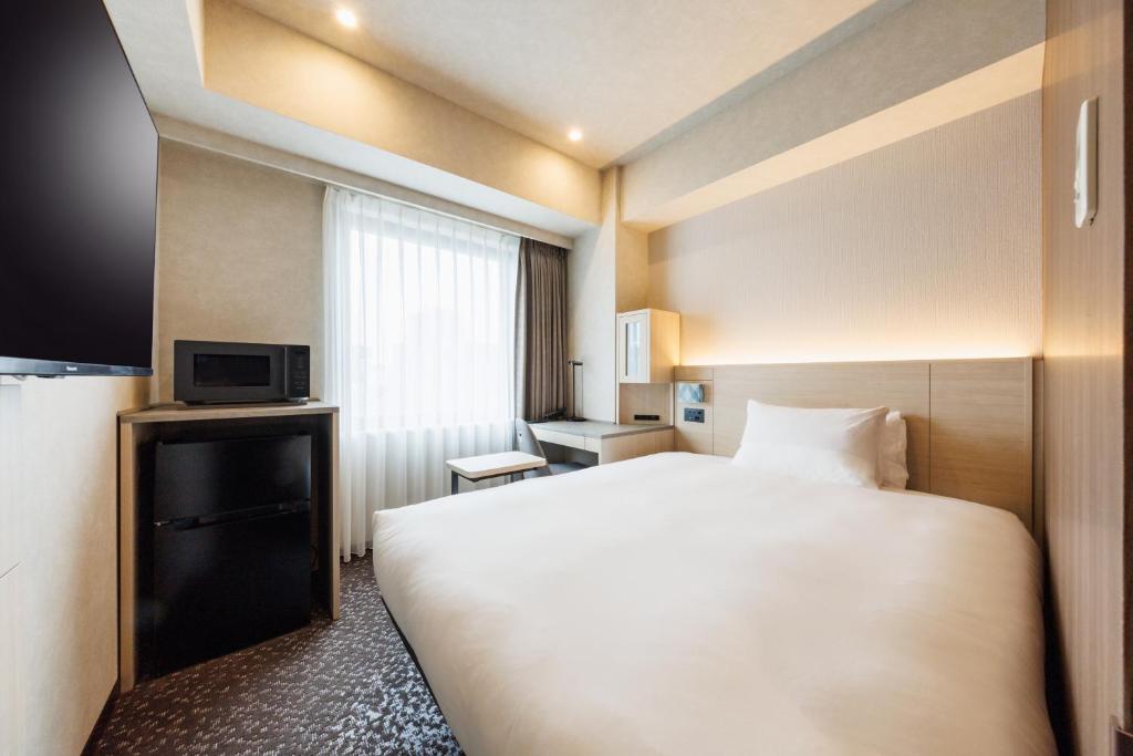 Postel nebo postele na pokoji v ubytování JR-East Hotel Mets Shibuya